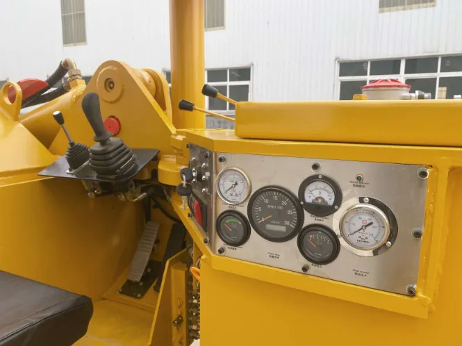 Operator control station of a diesel LHD showing joysticks, pedals, and instrument panel gauges used in underground mining operations