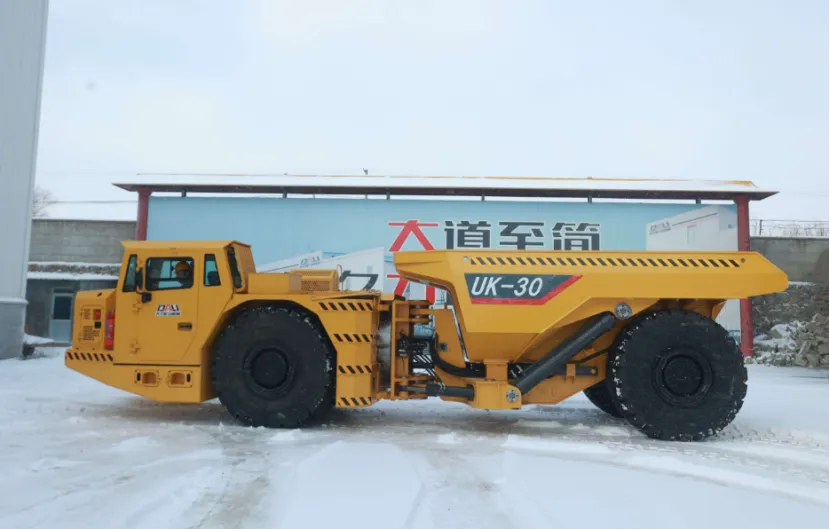 DALI UK-30 yellow underground mining truck fully loaded with rocks on a snowy outdoor lot