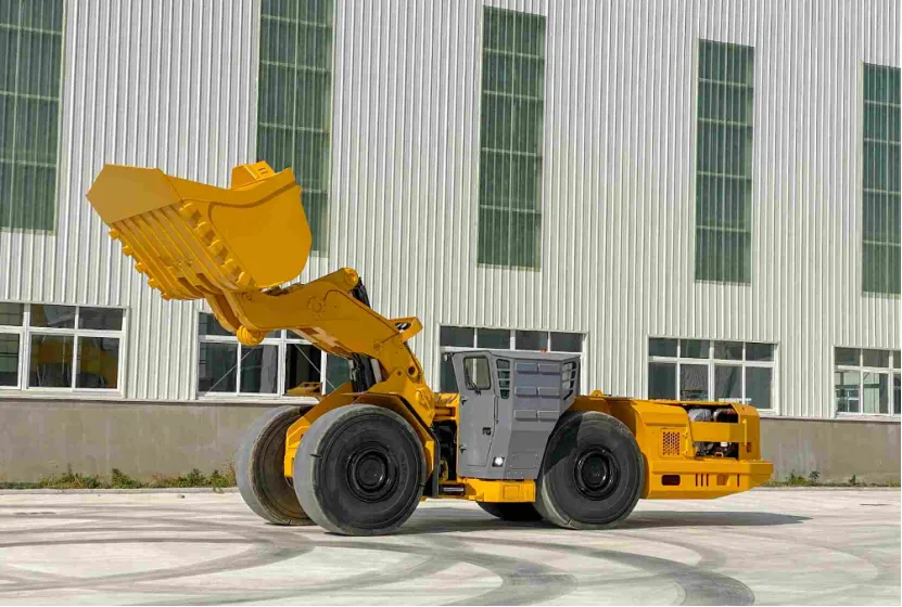 Yellow underground mining LHD loader with raised bucket