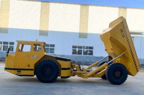 Side view of a yellow underground mining vehicle with an elevated dump box