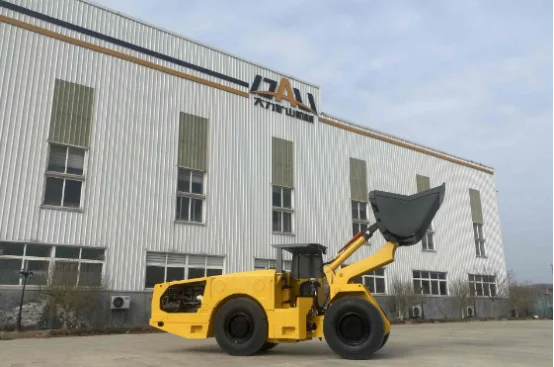 Yellow LHD loader with bucket raised