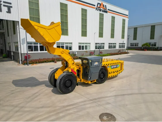 Yellow battery mining LHD loader with raised bucket